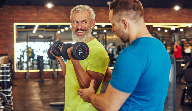 Coach guiding a client through resistance training