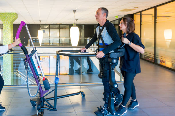 Therapist assisting a patient in a robotic gait trainer