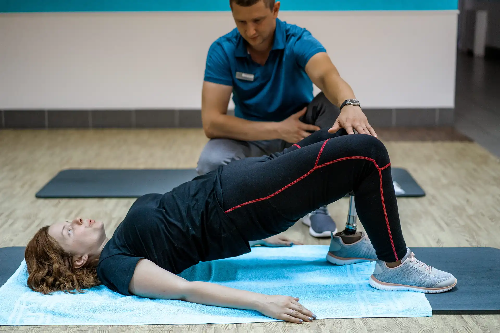 Physical therapist guiding a patient through a bridge exercise