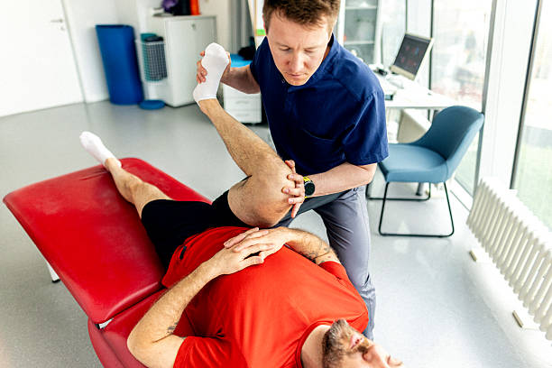 Therapist stretching a patient's hamstring
