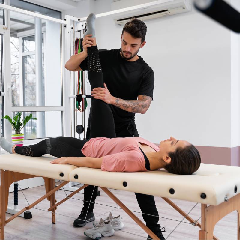 Supine leg stretch on a treatment table