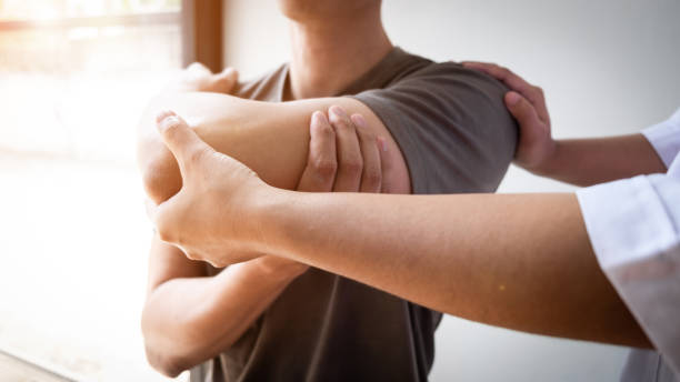 Clinician assessing a patient's elbow