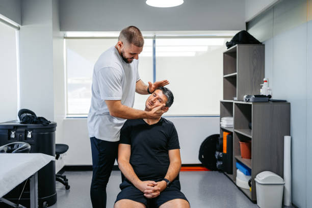 Therapist performing a neck assessment